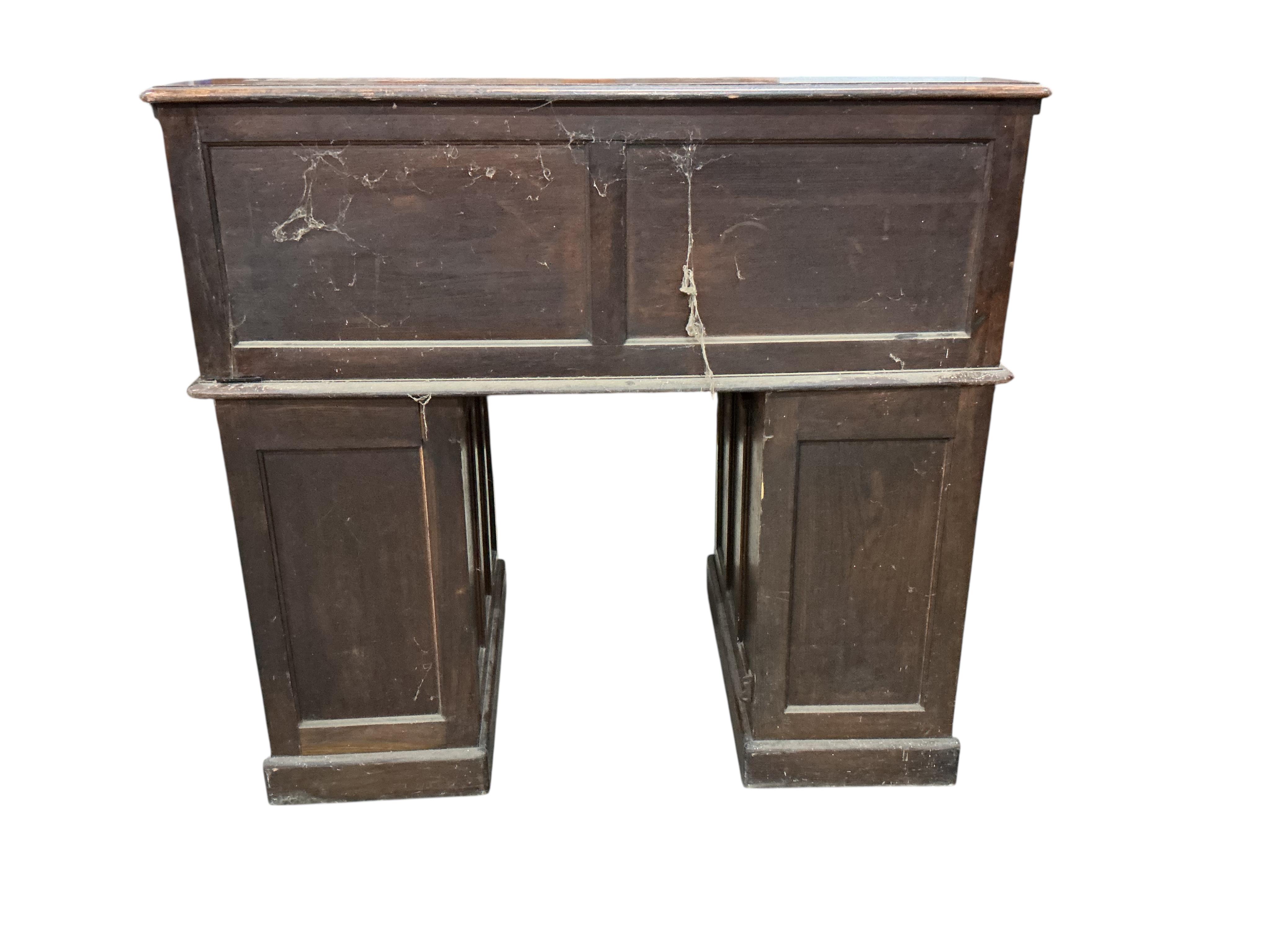 An early 20th century oak 'S' shaped tambour roll top desk, width 124cm, depth 78cm, height 120cm